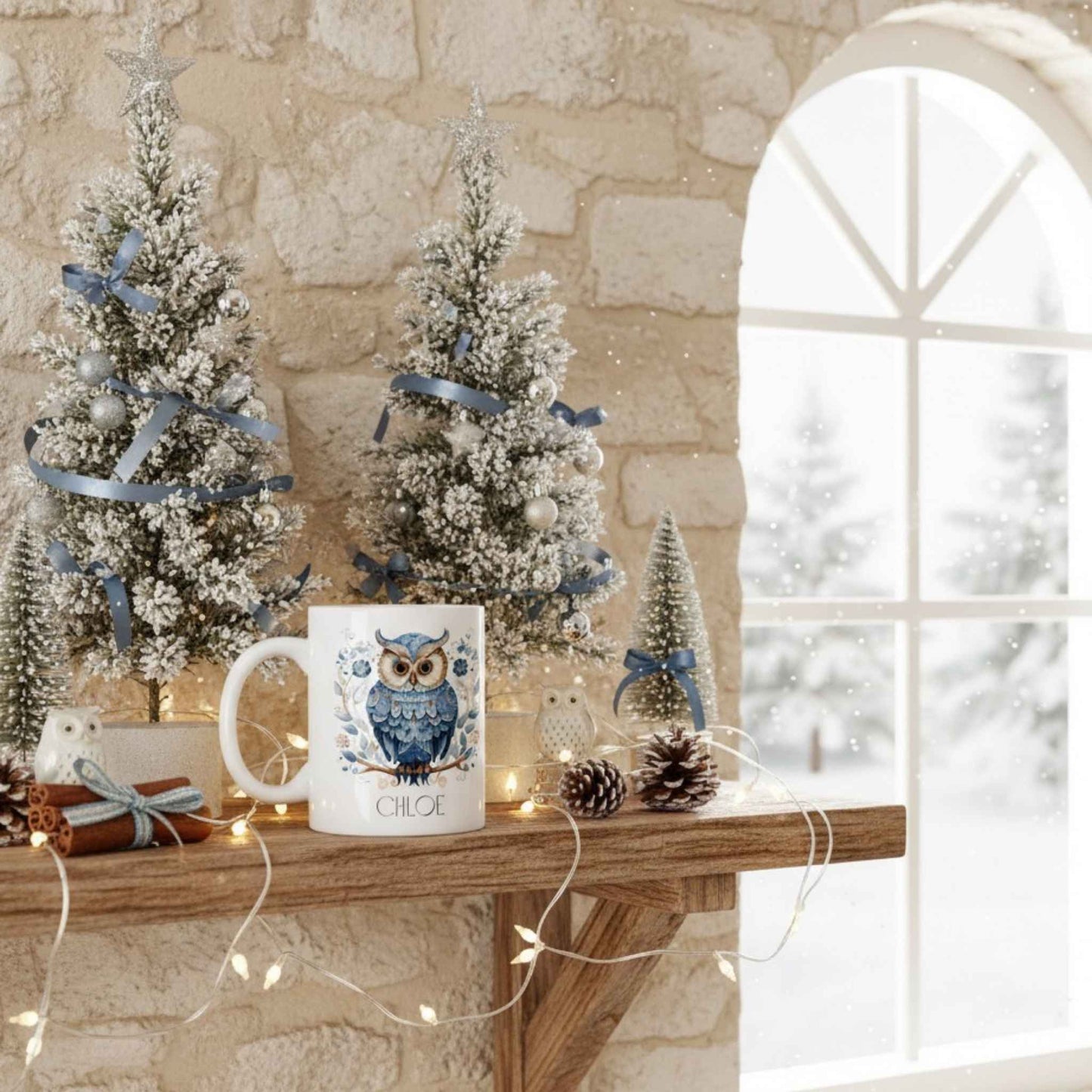 Decorative setup with Christmas trees and a mug featuring an owl design on a stone wall background.