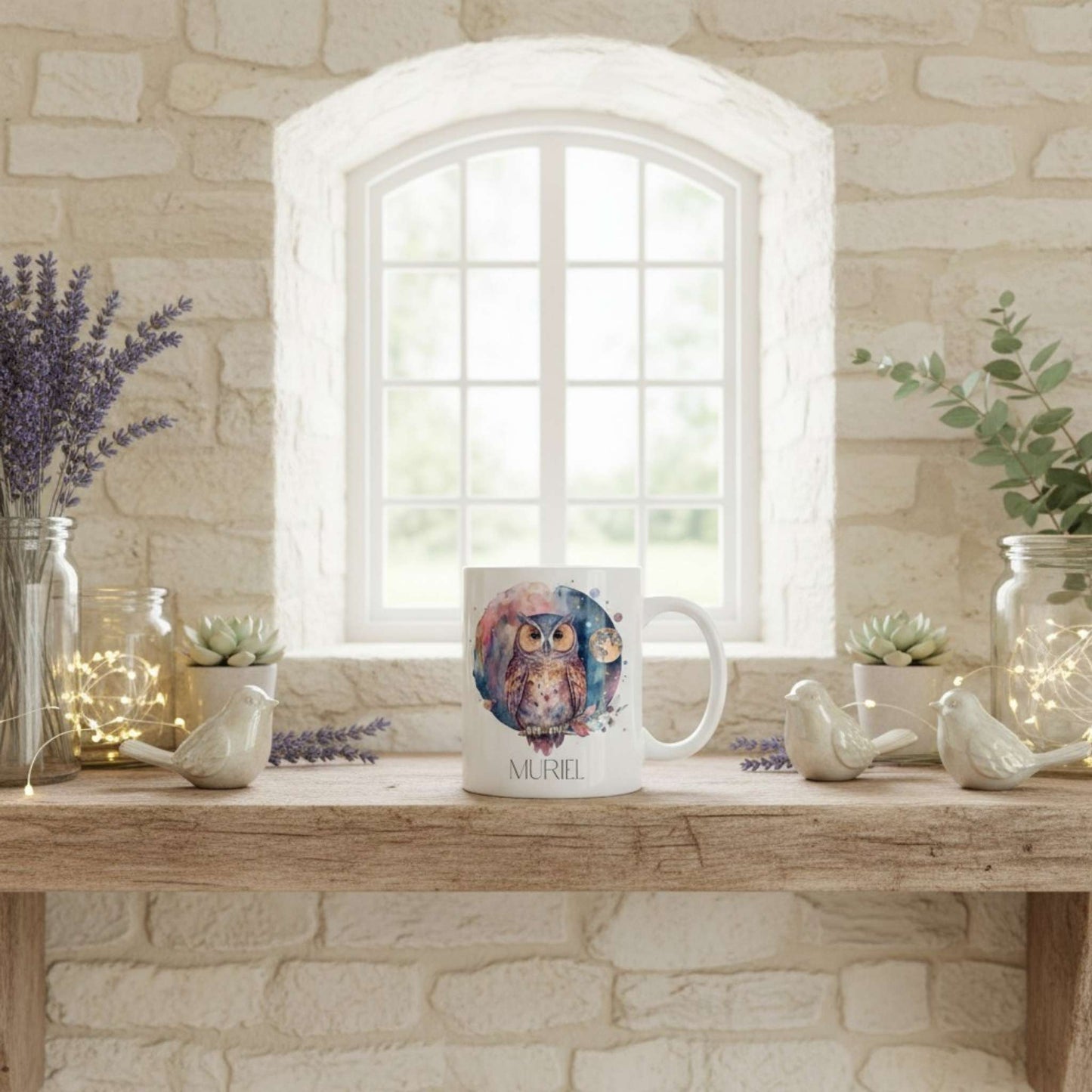 Mug with owl design on a wooden table in a room with stone walls and a window. Christmas decorations are on display.