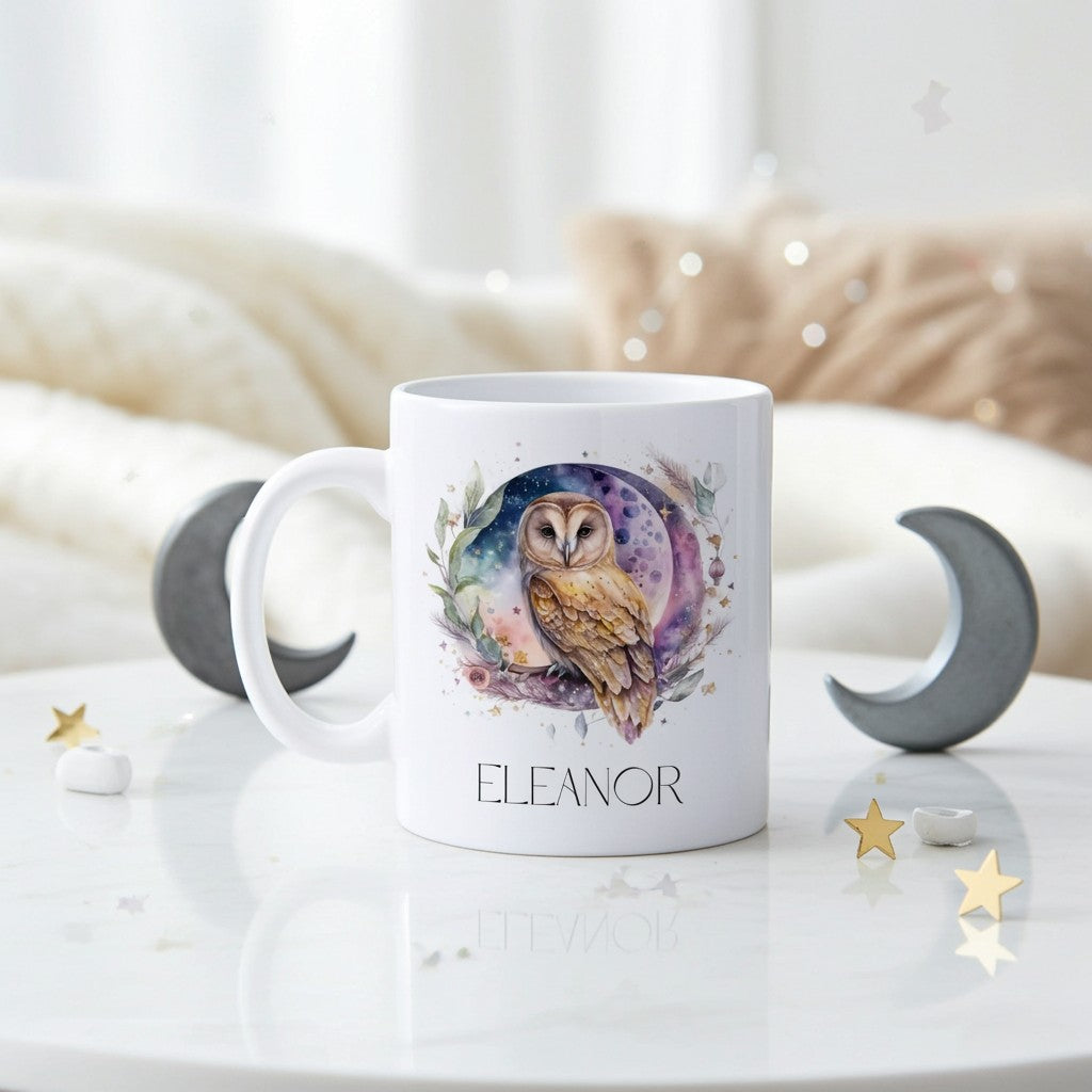 White mug with owl design and 'Eleanor' text on a white surface with decorative elements.