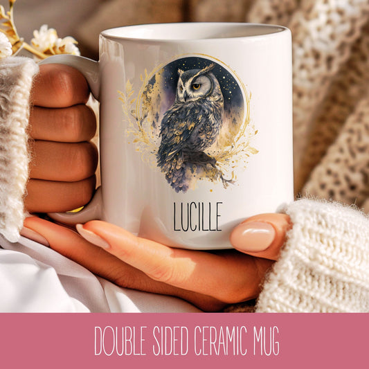 A white ceramic coffee mug with an owl design and custom name 'Lucille' printed on the side, held in a person's hand.