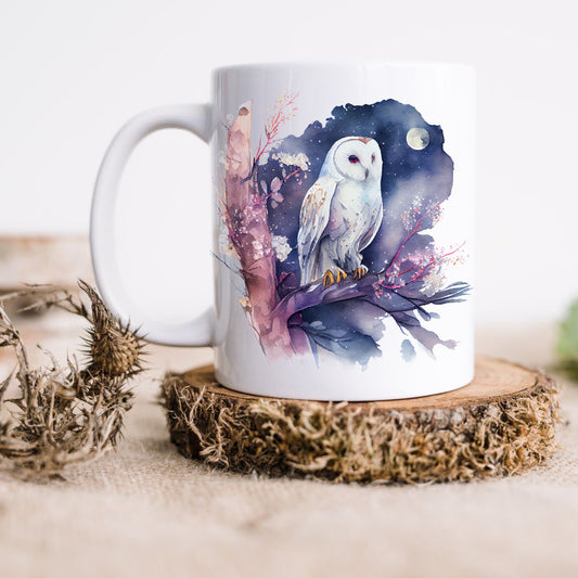 A ceramic coffee mug with a colourful illustration of an owl sitting on a branch under the moonlight.