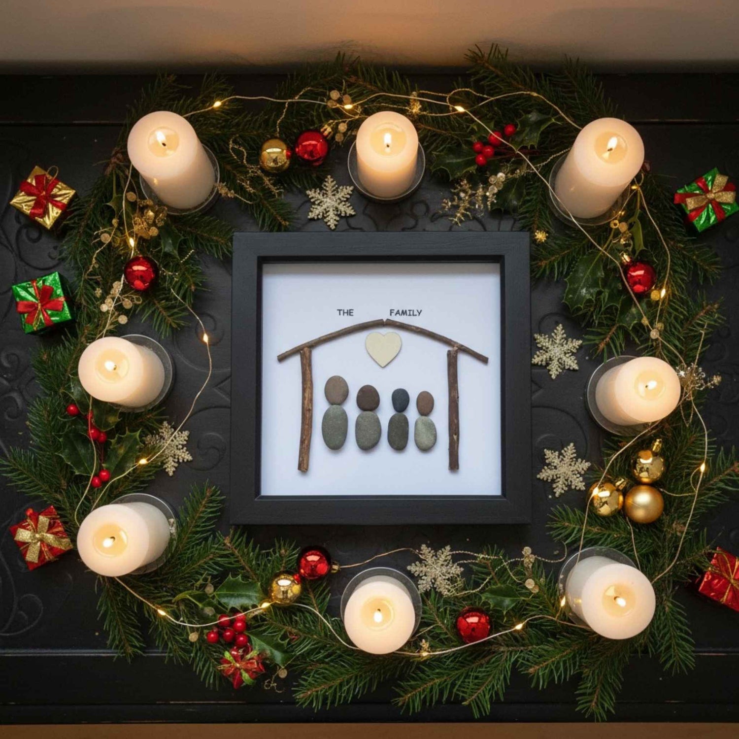 Decorative wreath with candles, ornaments, and a framed family portrait on a dark background.