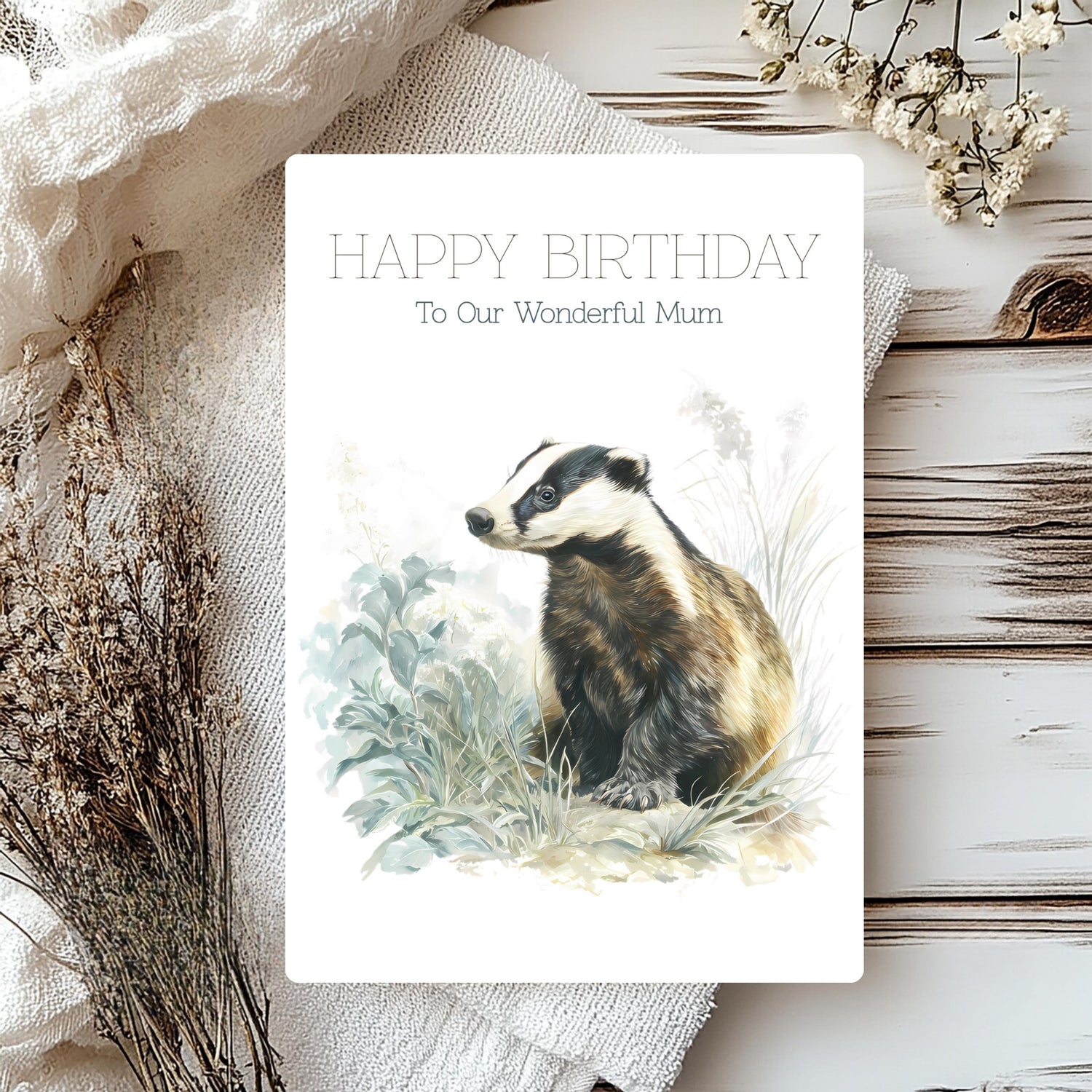 Birthday card with a badger illustration and 'Happy Birthday to Our Wonderful Mum' text, surrounded by natural elements.