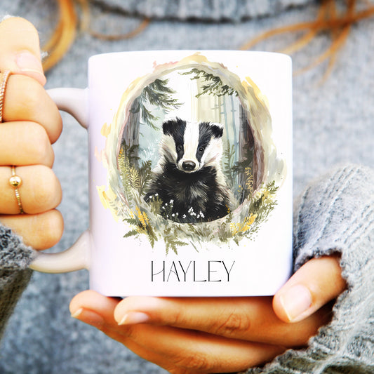 Person holding a mug with a badger design and 'Hayley' text.