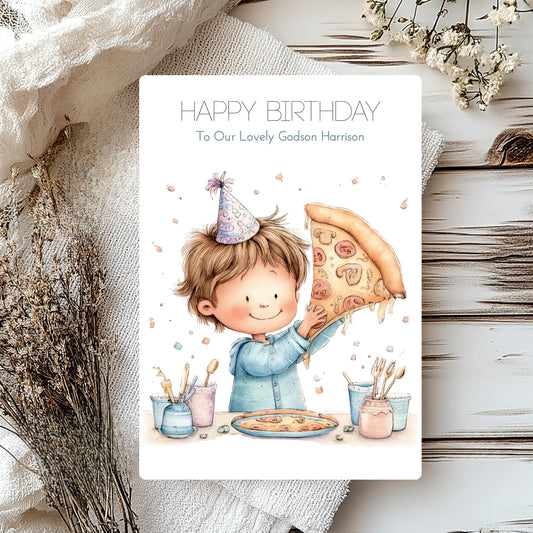 Birthday card with illustration of a boy holding a pizza, surrounded by decorative elements on a wooden surface.