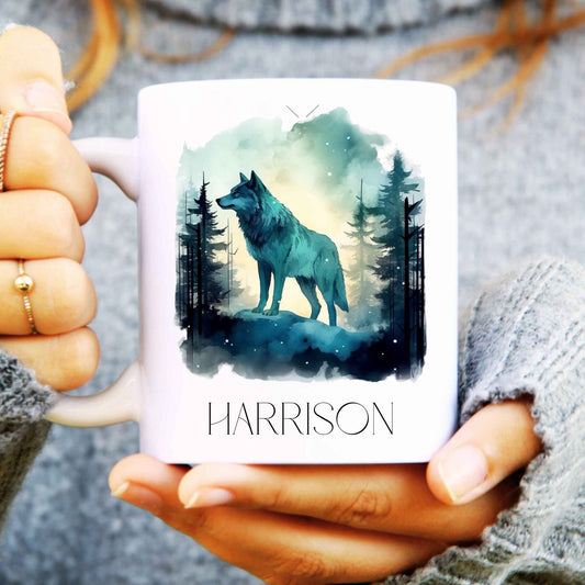 Person holding a mug with a wolf design and 'HARRISON' text
