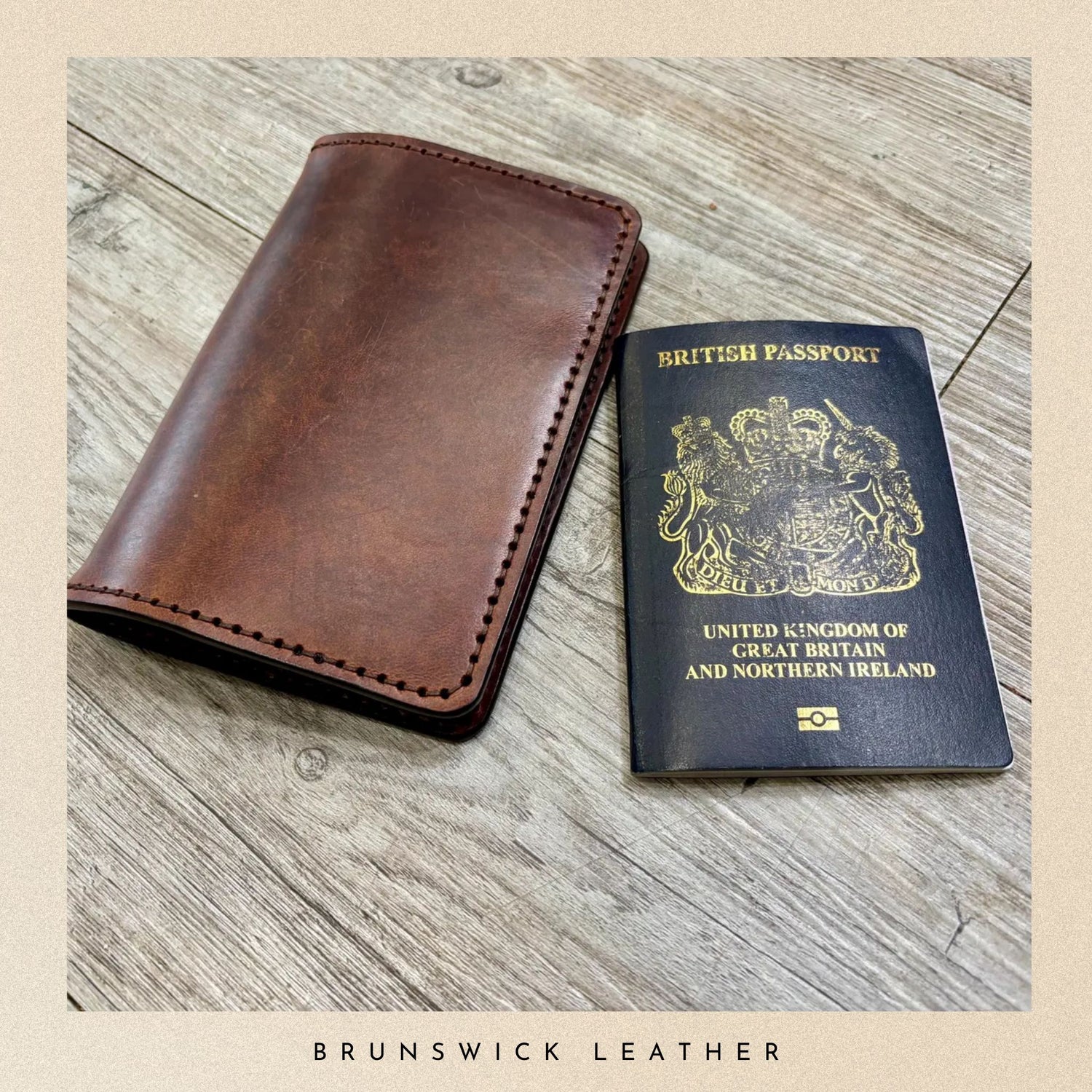 Brown leather wallet and British passport on a wooden surface with 'Brunswick Leather' branding.