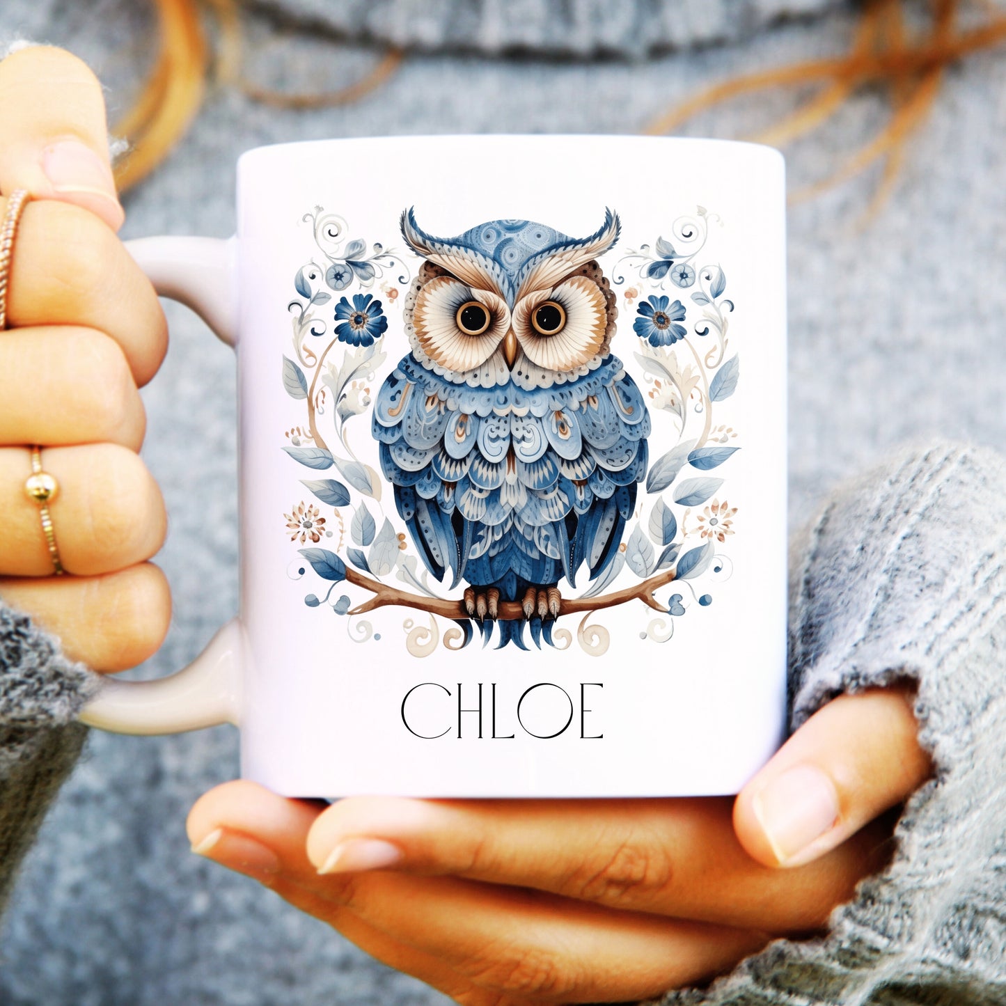 Person holding a mug with a blue owl design and 'CHLOE' text.