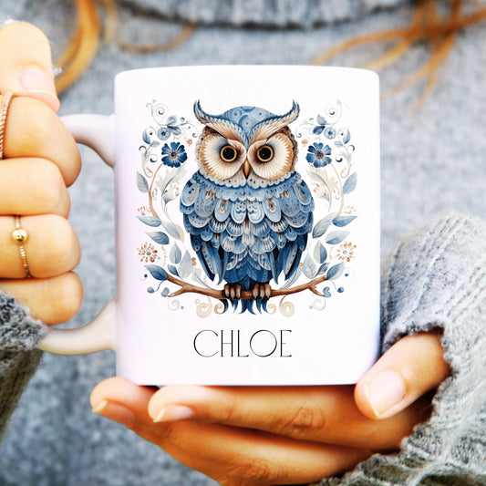 Person holding a mug with a blue owl design and 'CHLOE' text.