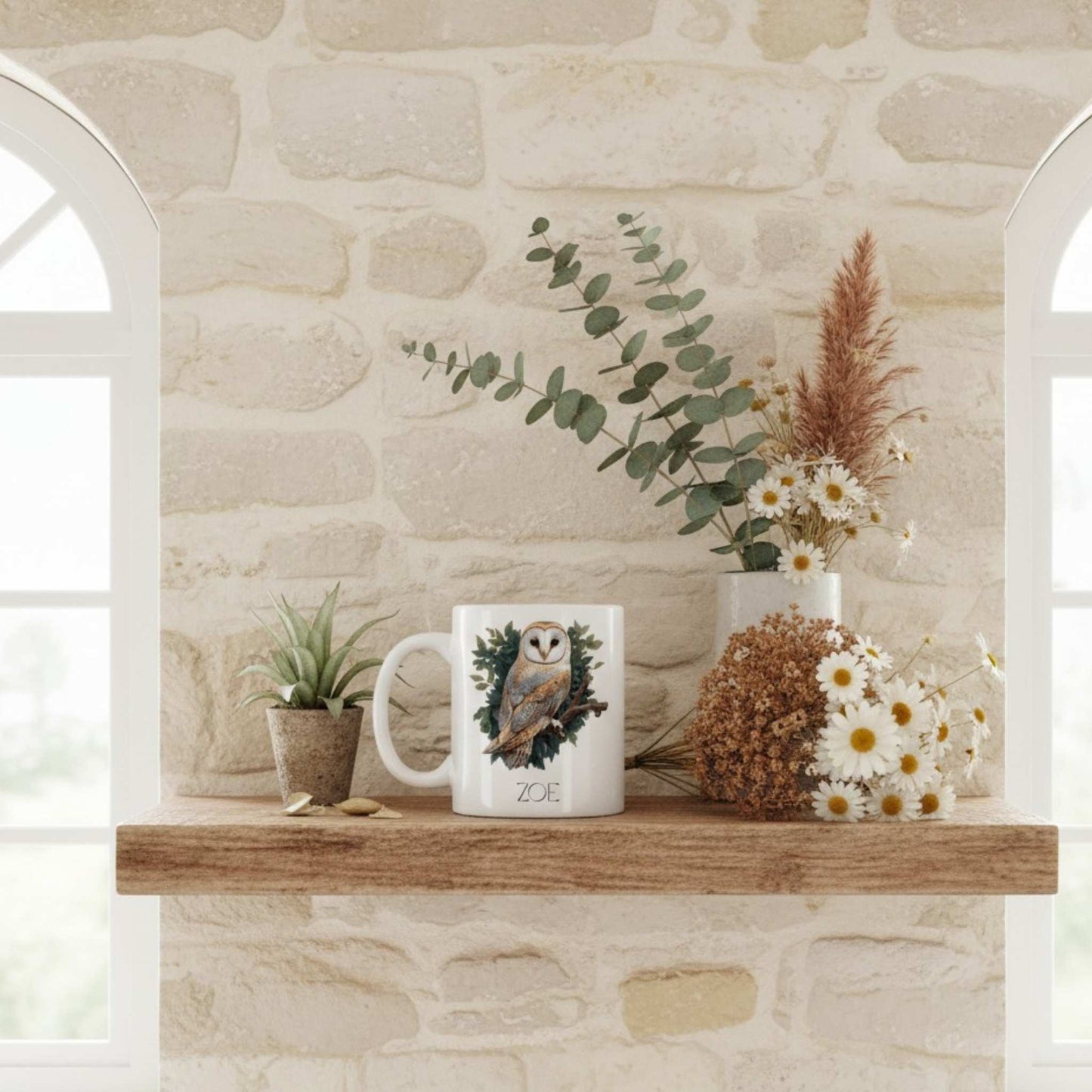 Mug with owl design on a wooden shelf against a stone wall