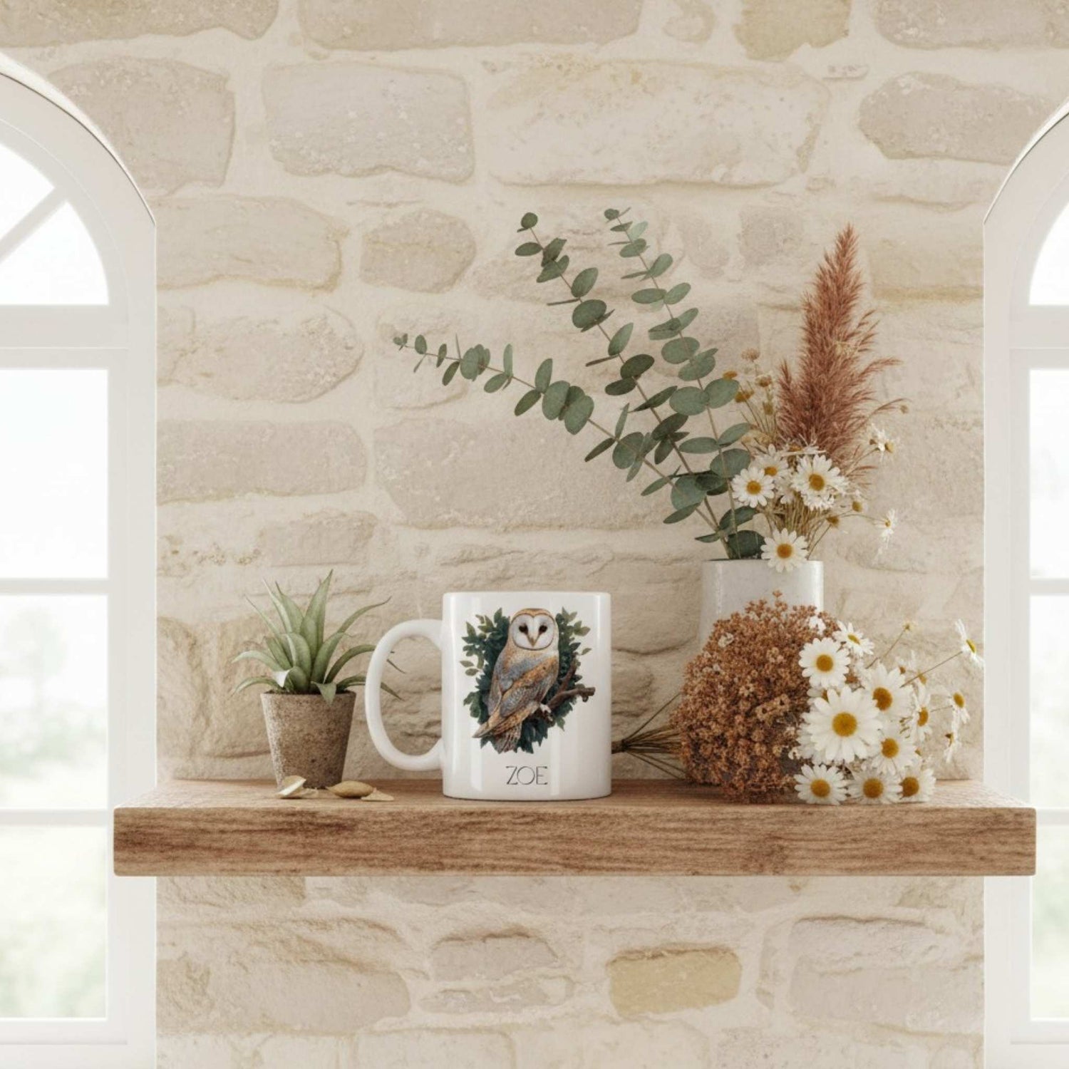 Mug with owl design on a wooden shelf against a stone wall