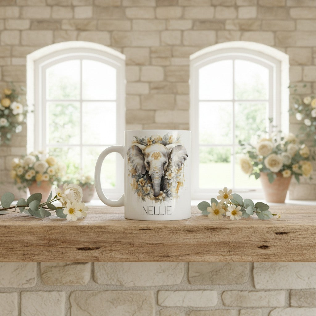 Mug with an elephant design and 'NELLIE' text on a wooden surface with flowers and a stone wall background