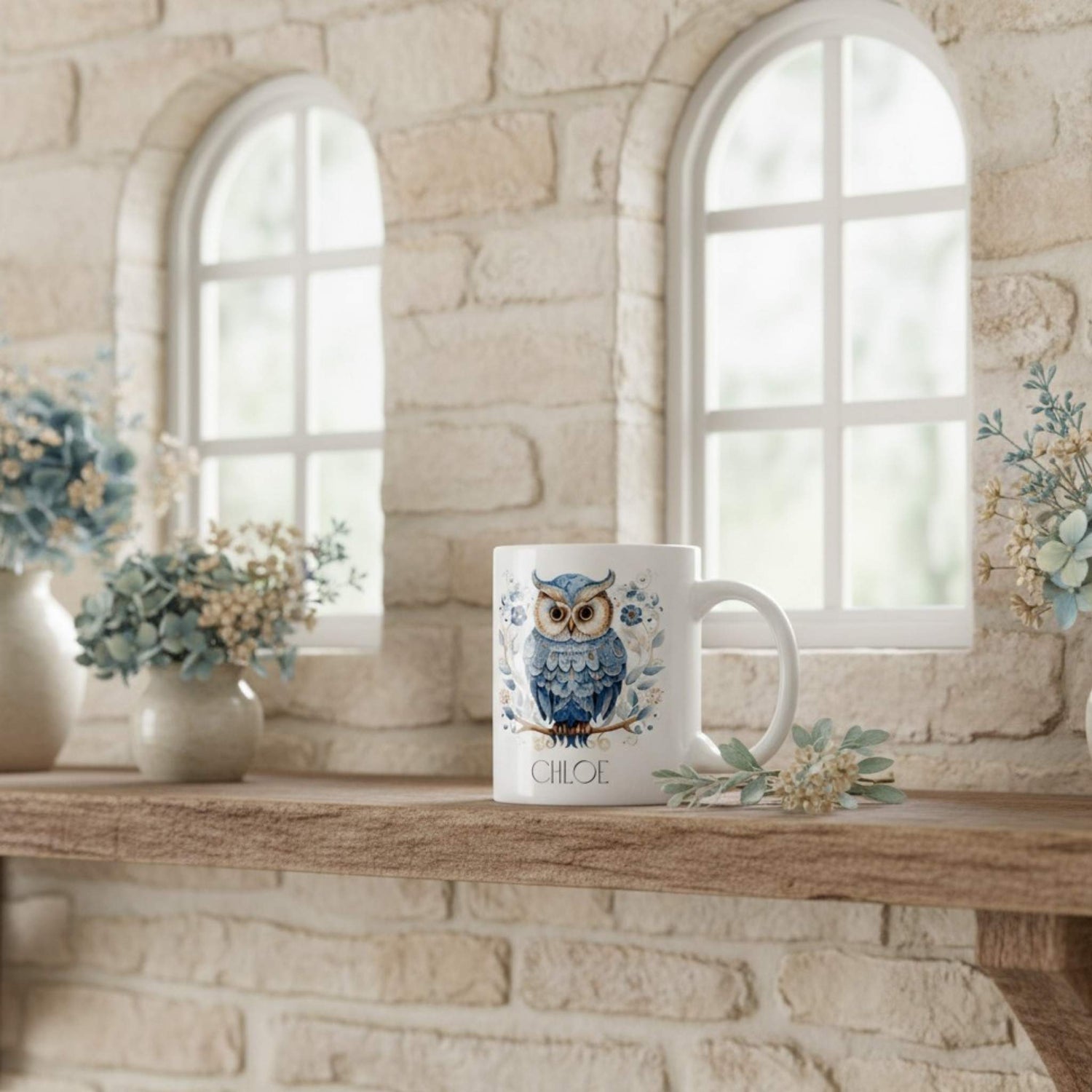 White mug with owl design on a wooden shelf against a stone wall background