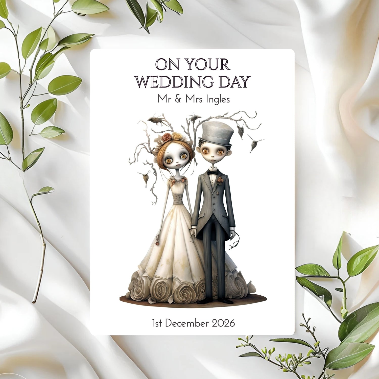 Personalised wedding card with cartoon gothic bride and groom illustration on a white background with green leaves.