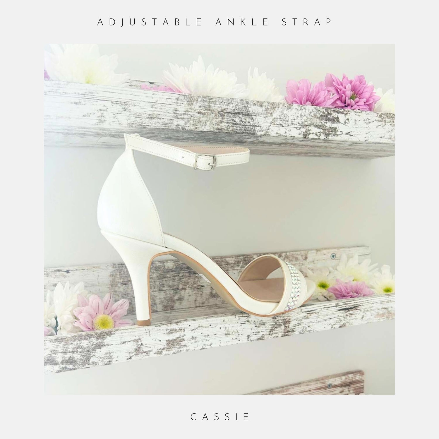 Ivory high-heeled shoe with adjustable ankle strap on a decorative shelf with flowers