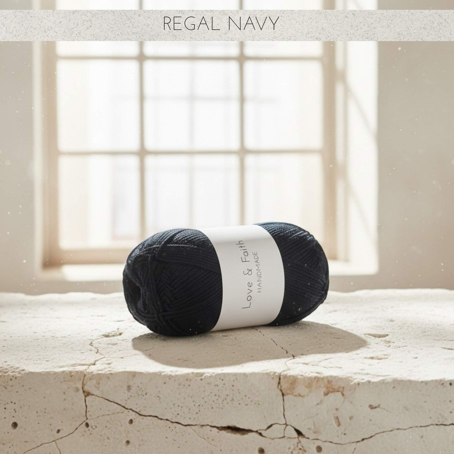 Ball of yarn labelled 'Love & Faith' on a stone surface with a window in the background