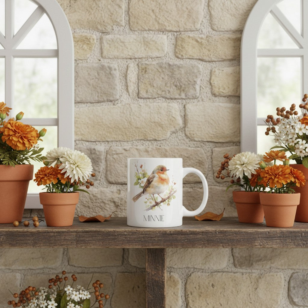White mug with a robin design on a wooden shelf against a stone wall.