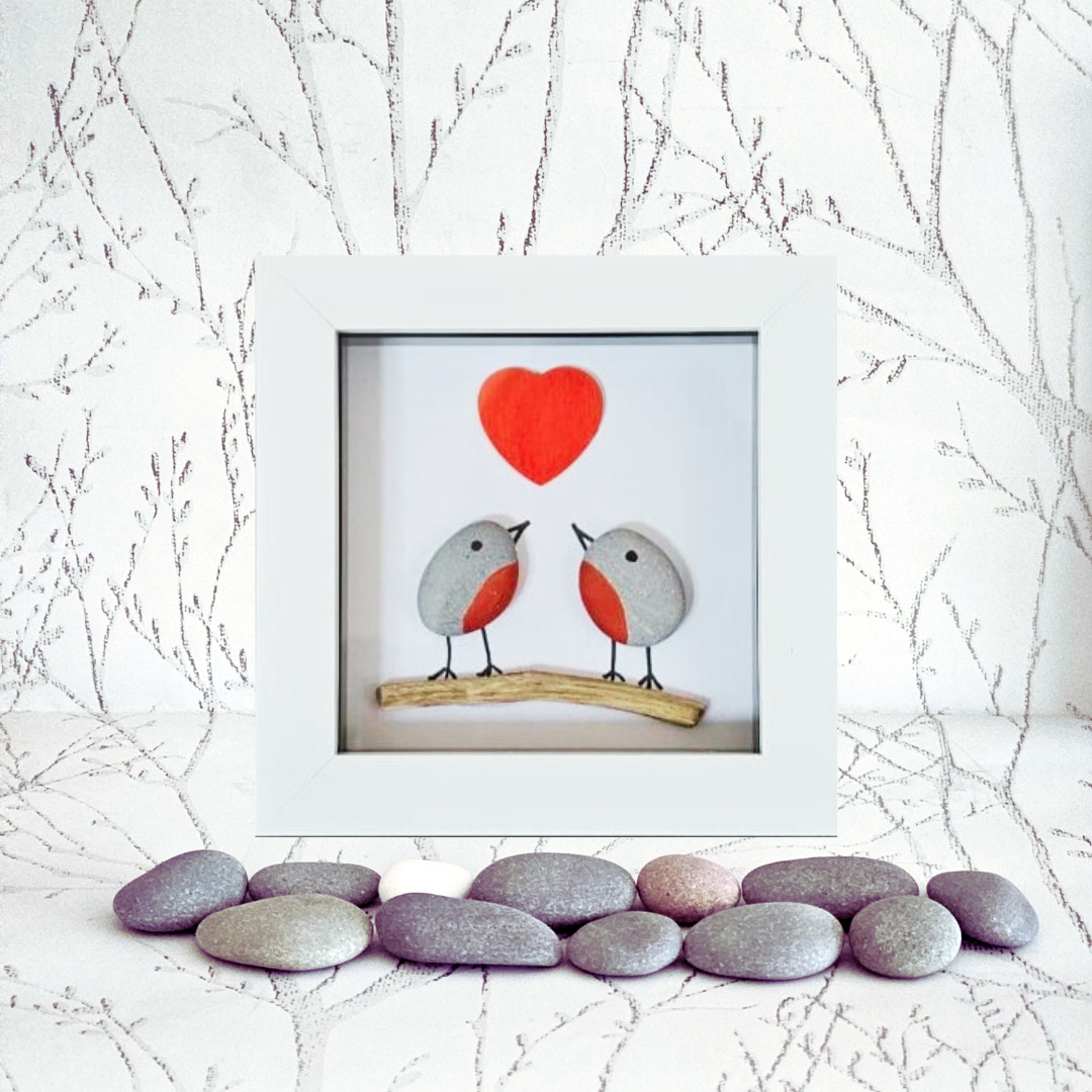 Framed artwork of two robins on a branch with a red heart above, set against a white background with branches.