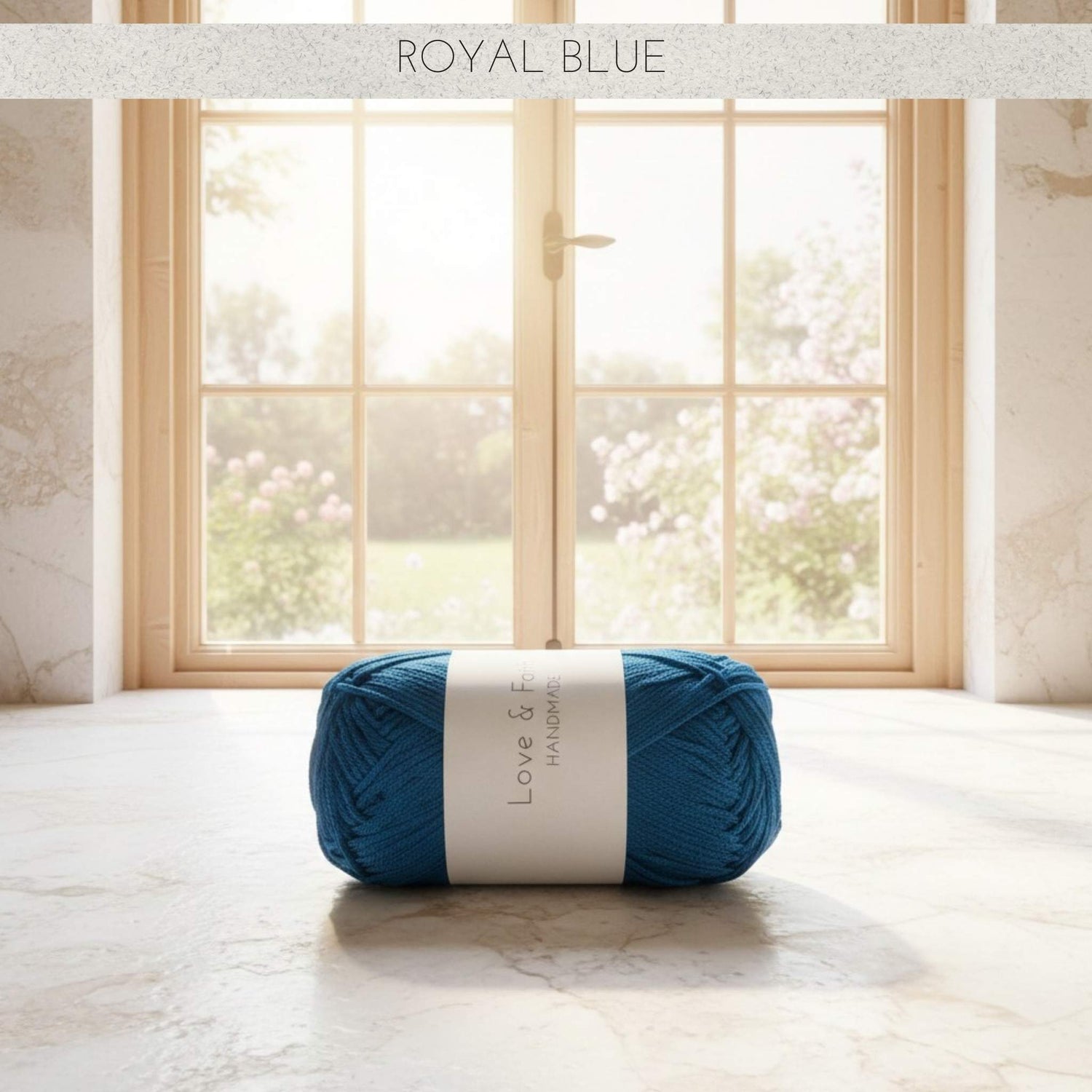 Ball of yarn labelled royal blue with a label in front of a window