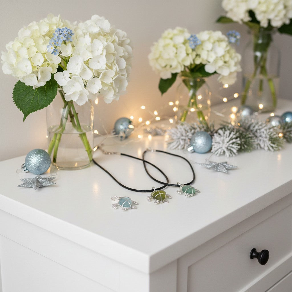 Decorative setup with flowers, ornaments, and sea glass jewellery on a white surface.