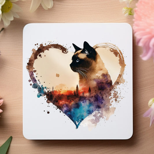 coaster with a siamese cat on a heart shaped frame with splash detail and white background.