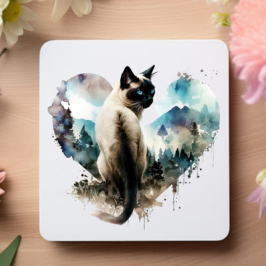 White coaster with a siamese cat on a heart with blue trees and mountains