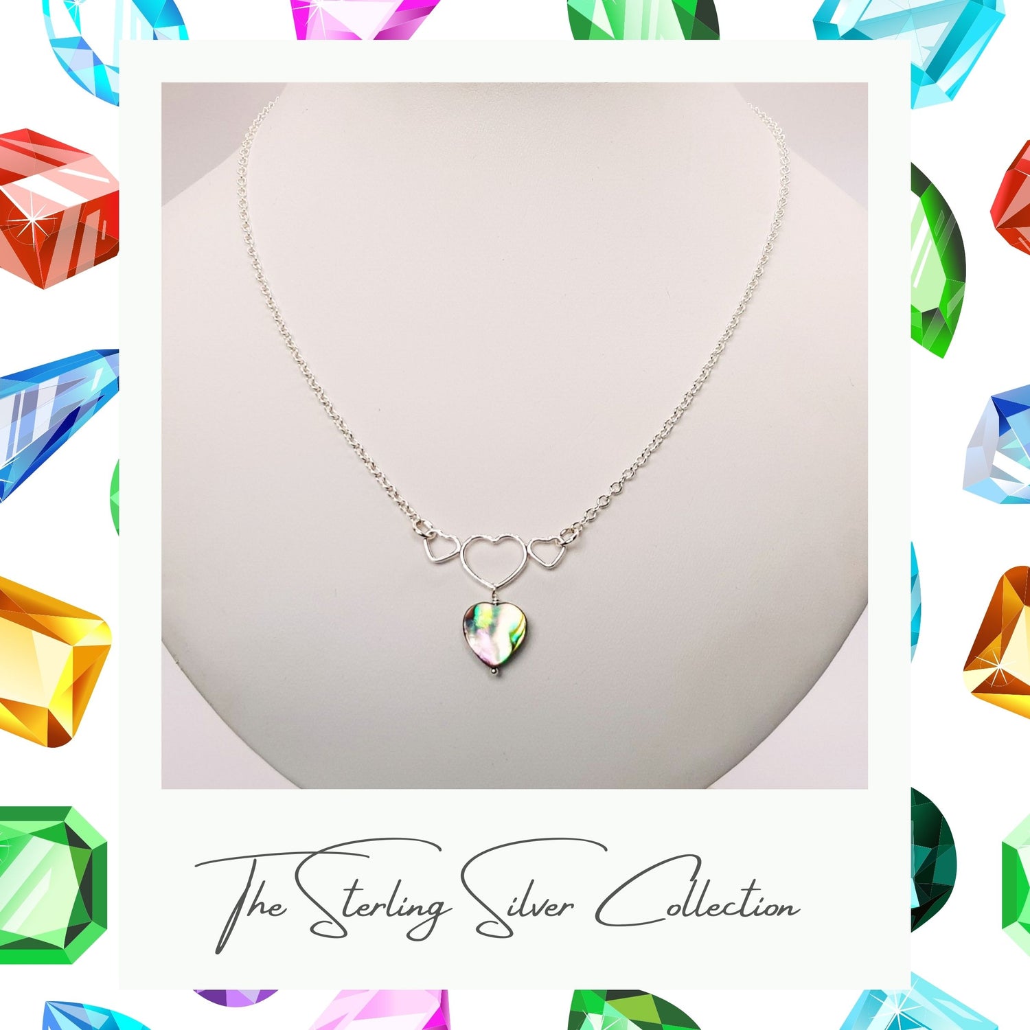 Pretty heart necklace on a stand, text reads sterling silver collection.