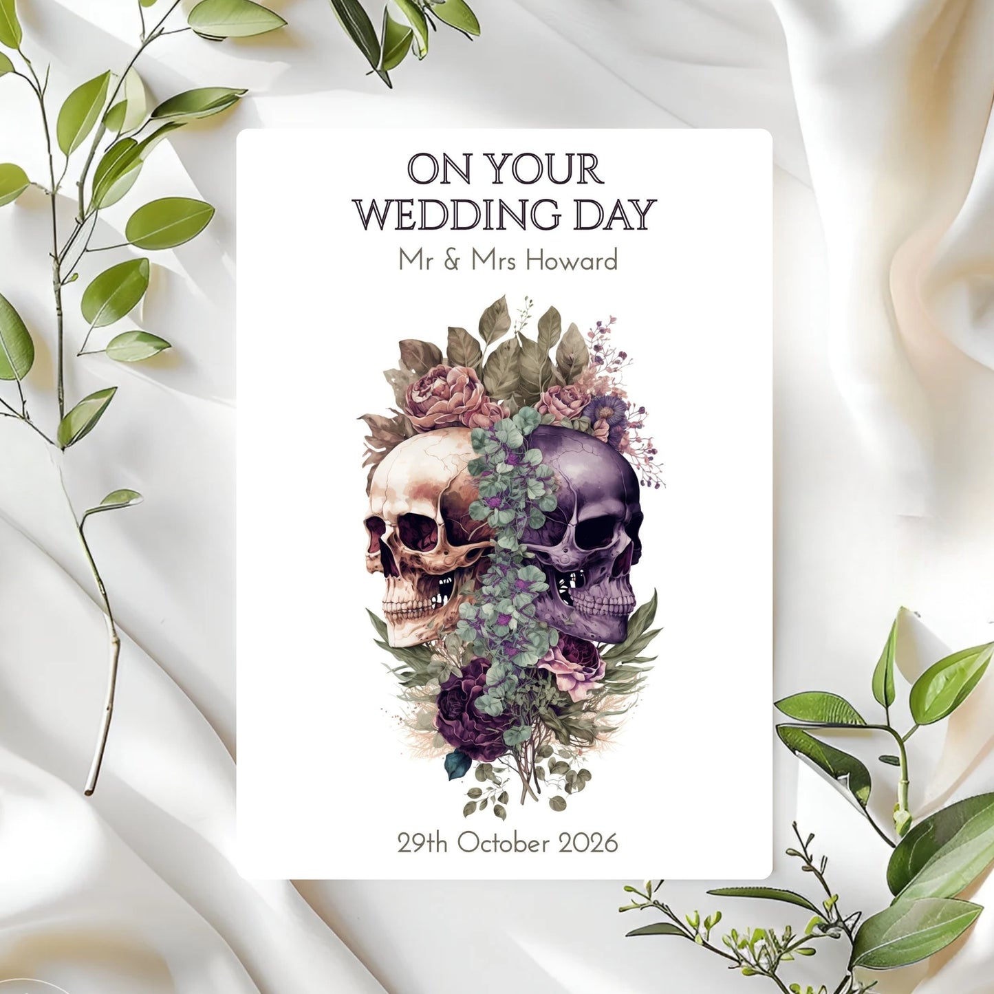 Wedding card with skulls and flowers on a white fabric background