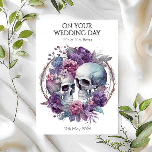 Personalised wedding card with skulls and flowers on a white fabric background