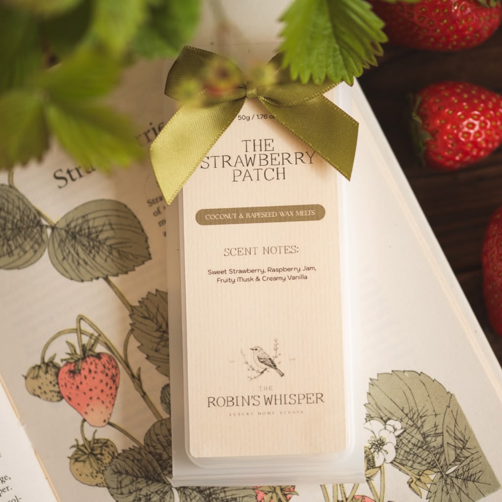 Product packaging of wax melts with a green ribbon on a strawberry-themed background
