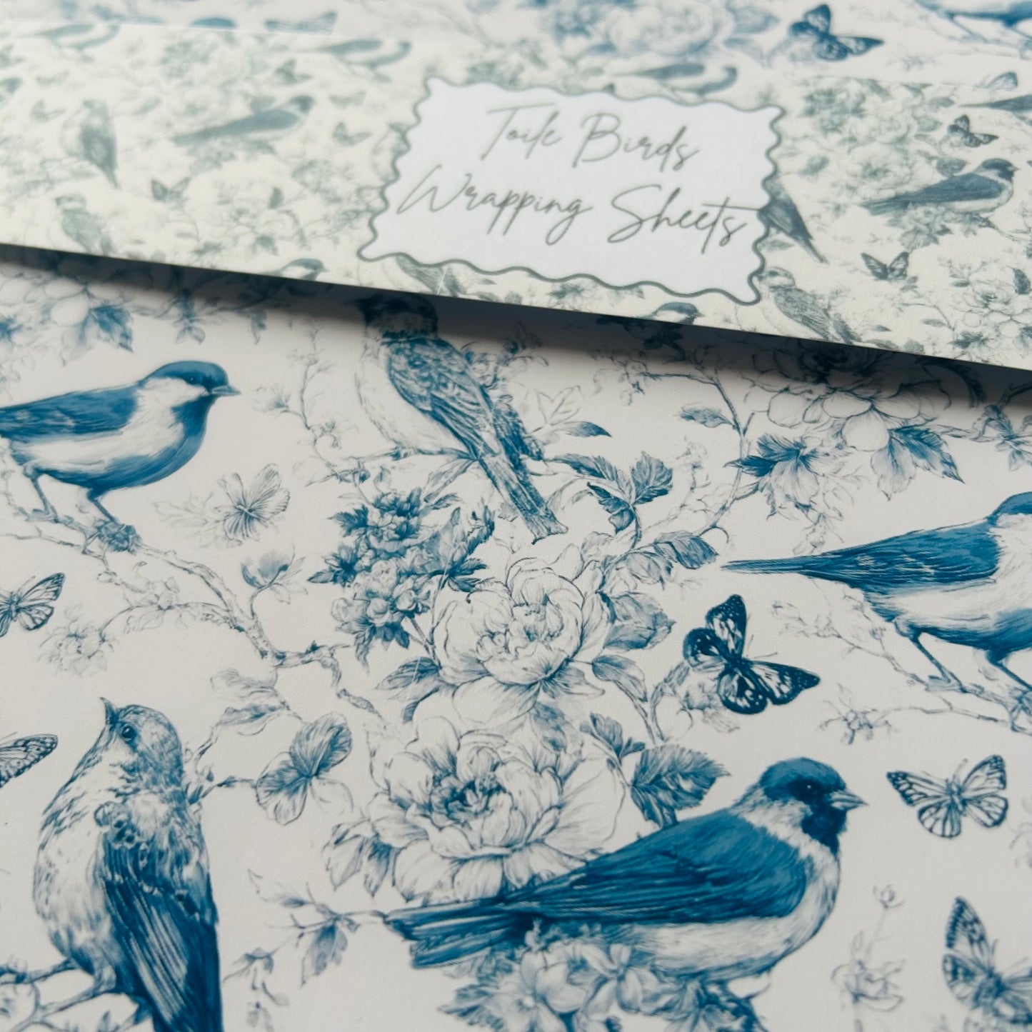 Bird and floral patterned wrapping paper with 'Toile Birds' branding.