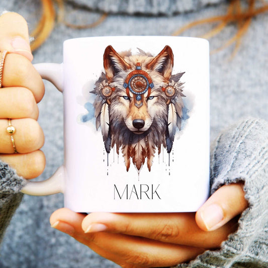 Mug with a wolf design and 'MARK' text held by hands against a blurred background