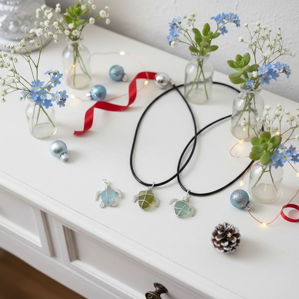 Necklaces with turtle pendants on a white surface with decorative elements