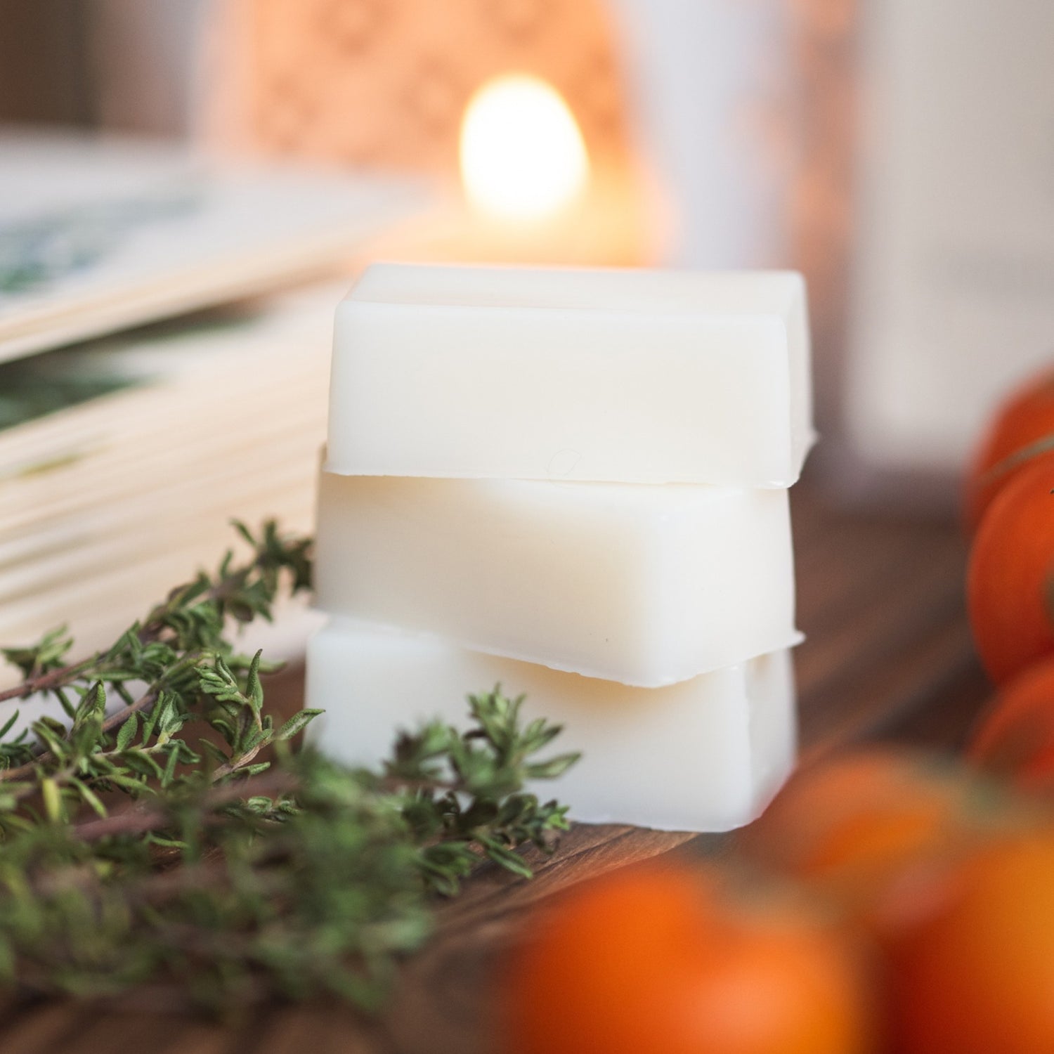 Wax melts with herbs and pumpkins on a wooden surface
