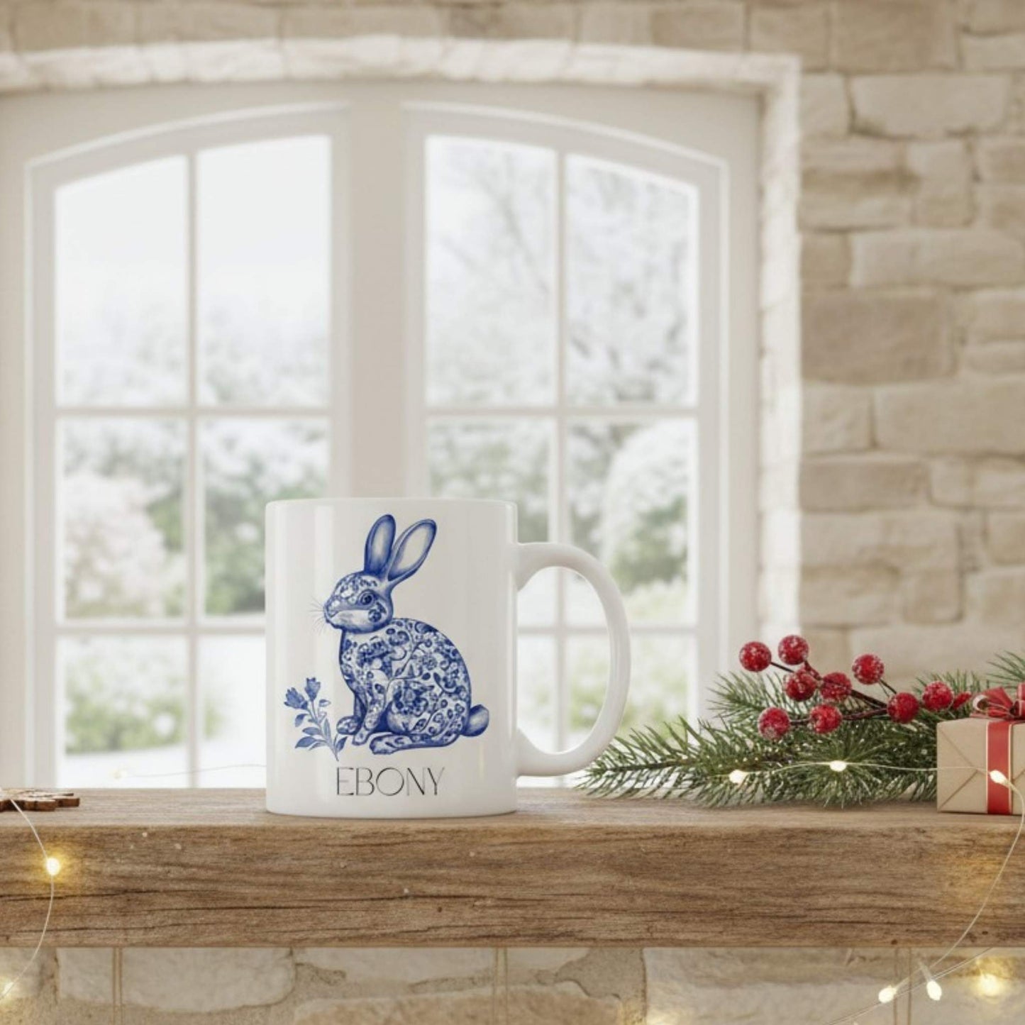 White mug with blue hare design on a wooden shelf with festive decorations