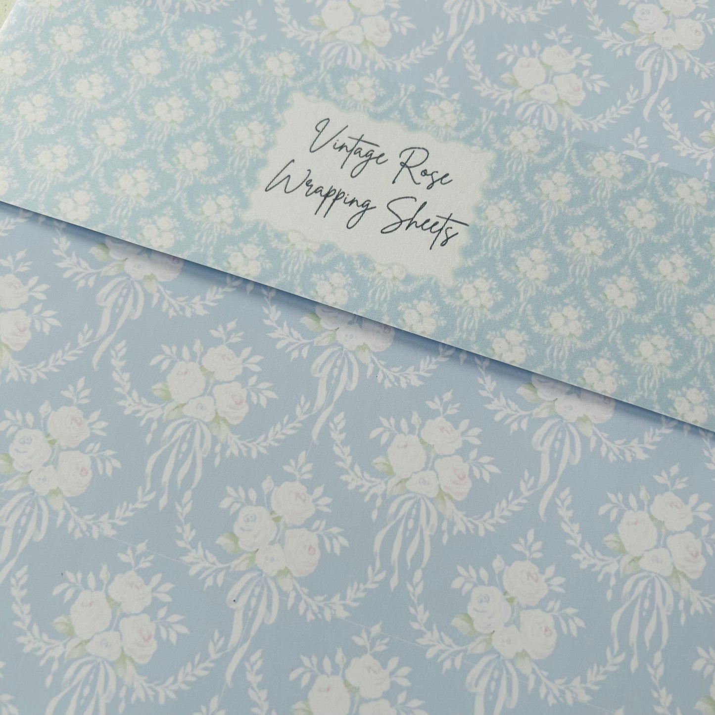 Floral patterned paper with 'Vintage Rose Wrapping Sheets' text