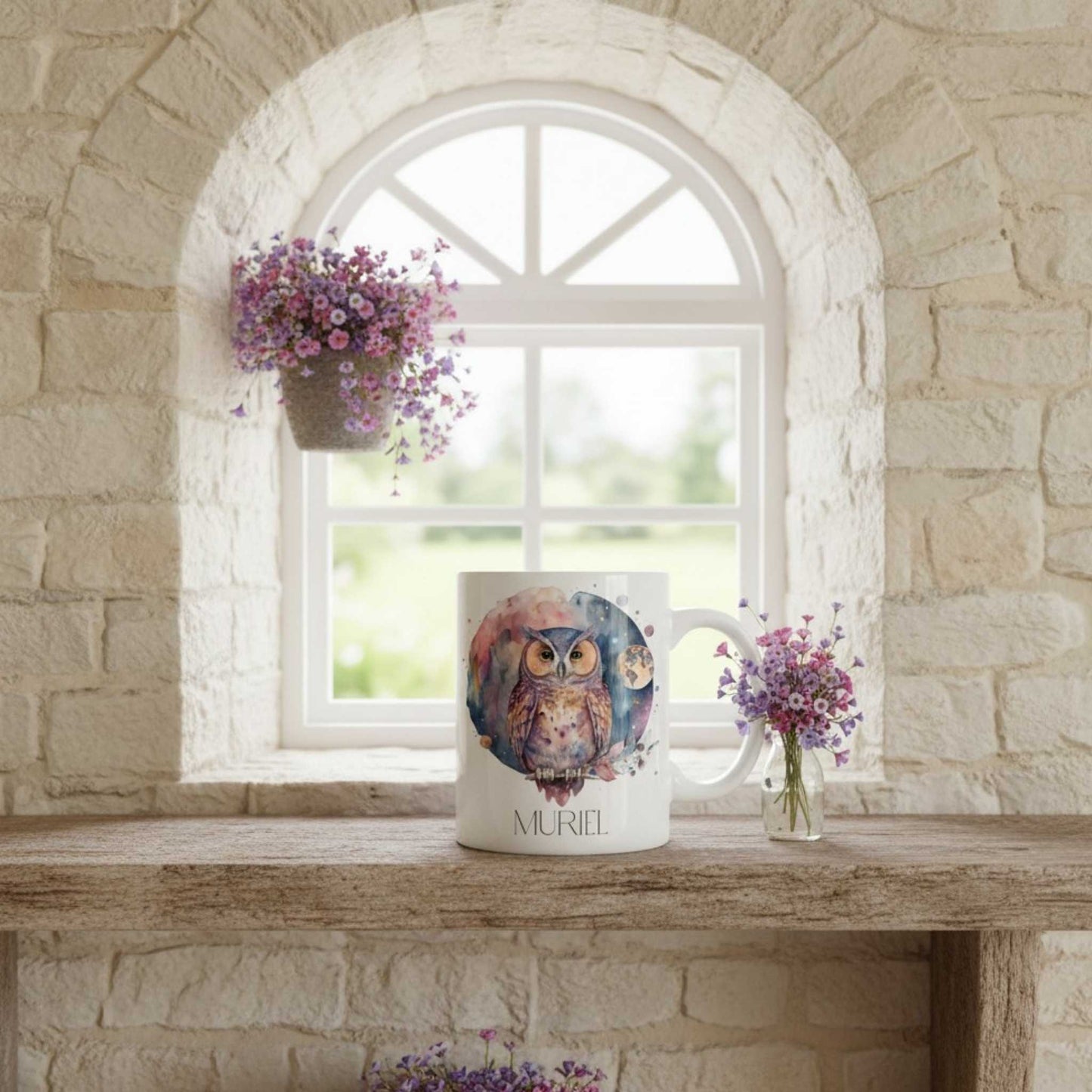 Mug with owl design on a stone ledge with flowers and a window in the background