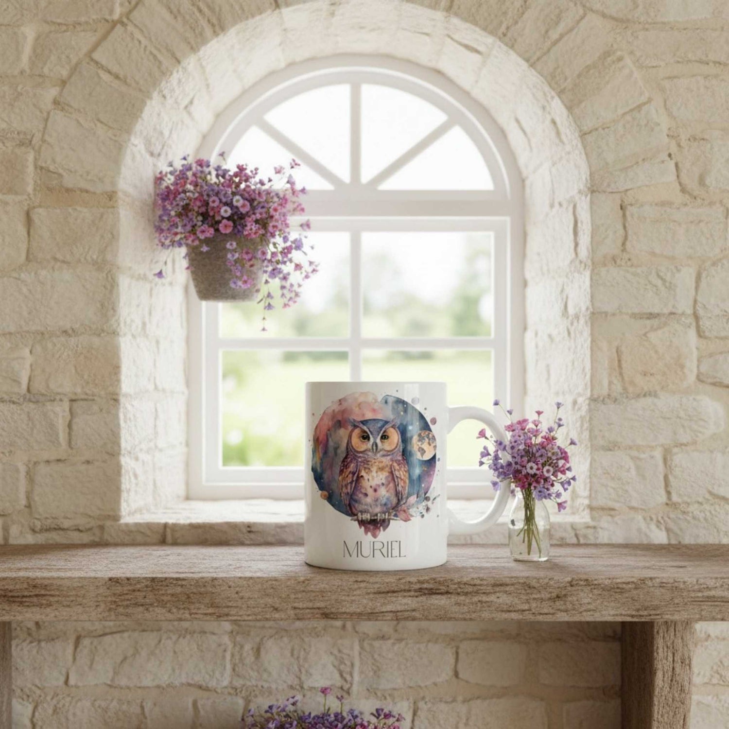 Mug with owl design on a stone ledge with flowers and a window in the background