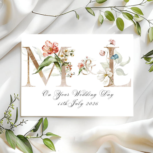 Wedding card with floral design and text on a white fabric background