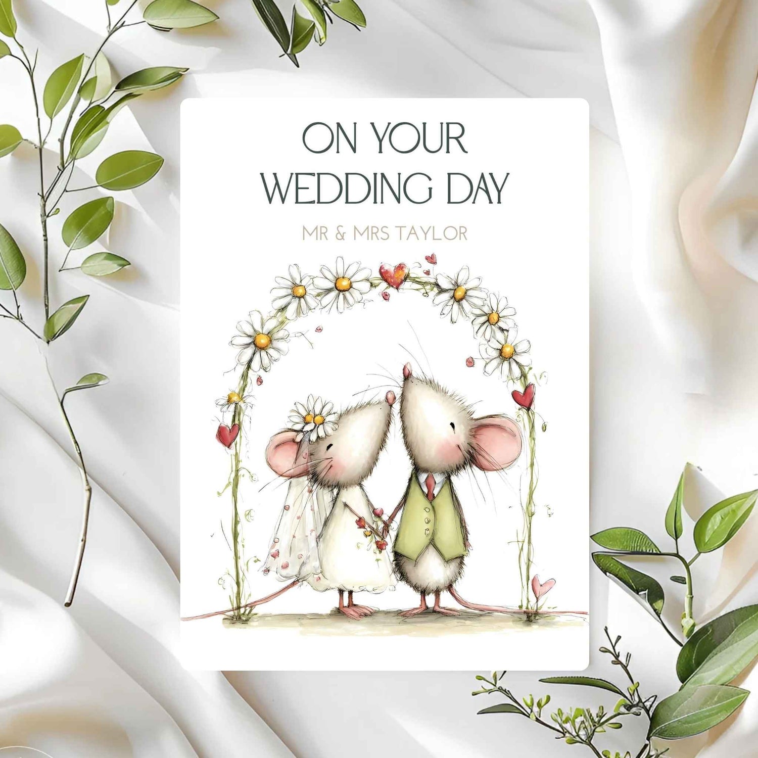 Wedding card with cartoon mice holding hands and text 'On Your Wedding Day' on a white background with green leaves.