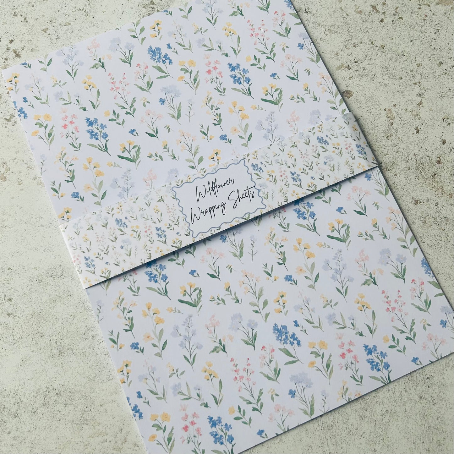 Floral-patterned paper sheets on a textured surface