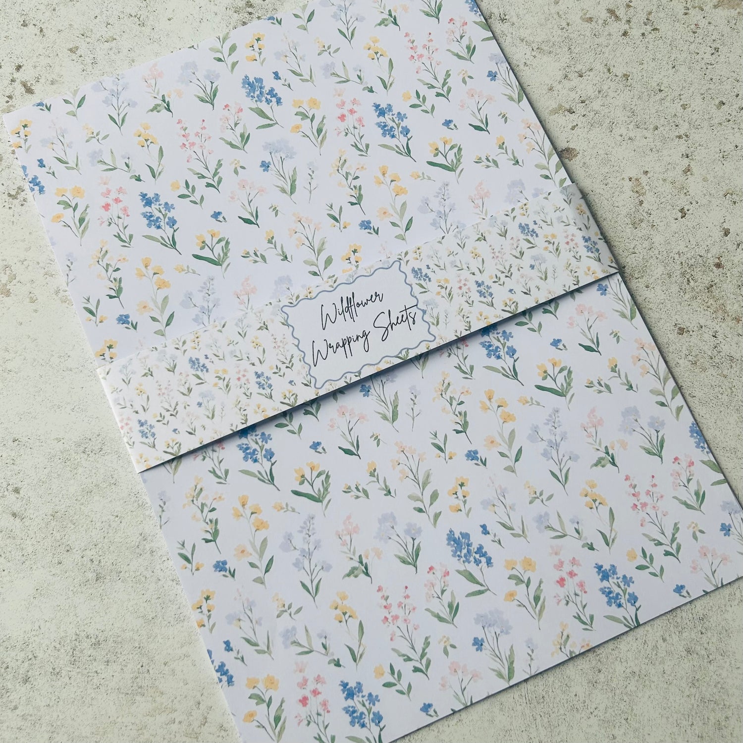 Floral-patterned paper sheets on a textured surface