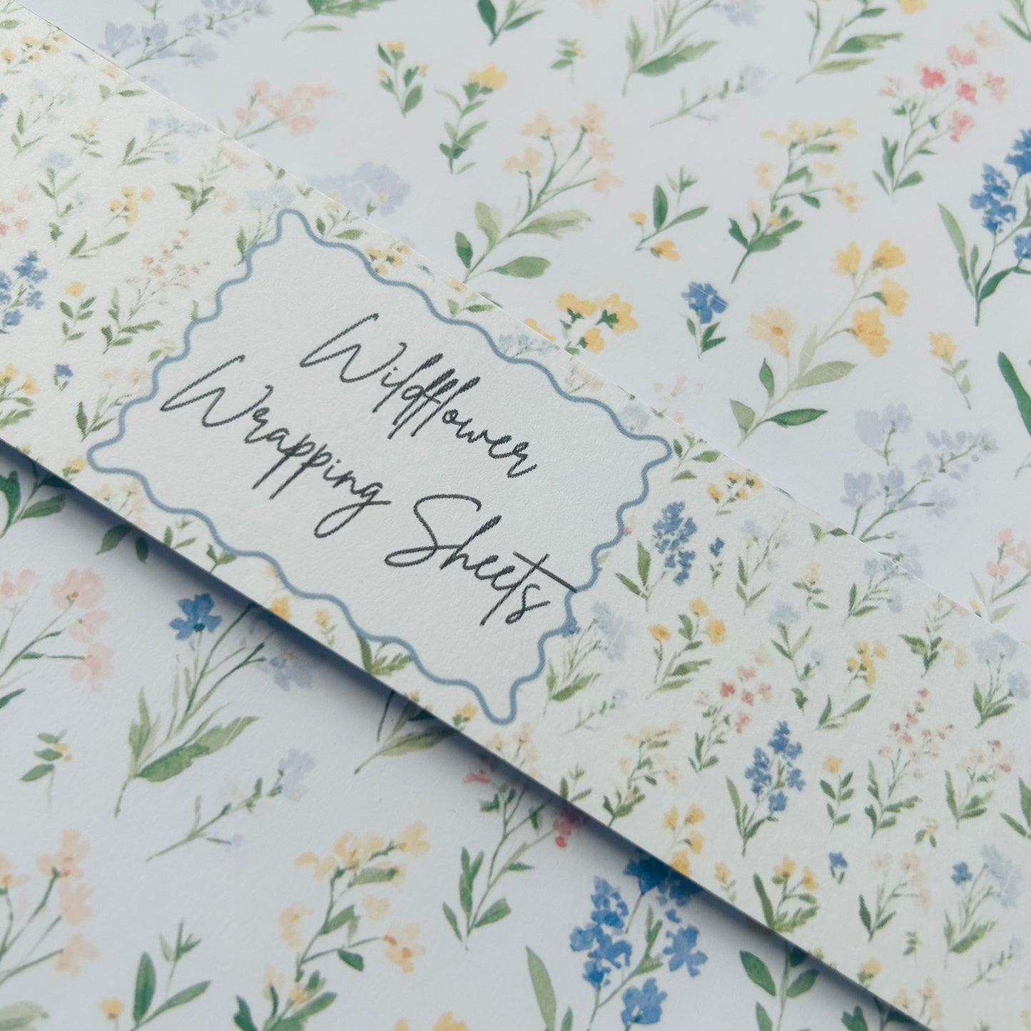 Wildflower wrapping sheets with a floral pattern on a light off white background