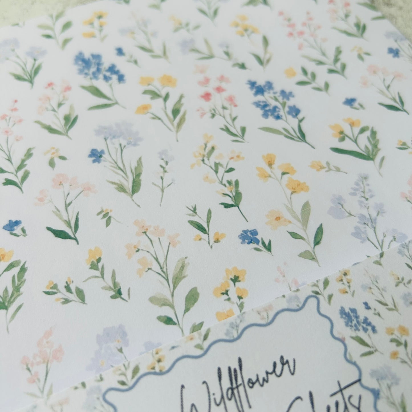 Floral pattern with small flowers and leaves on a light blue background