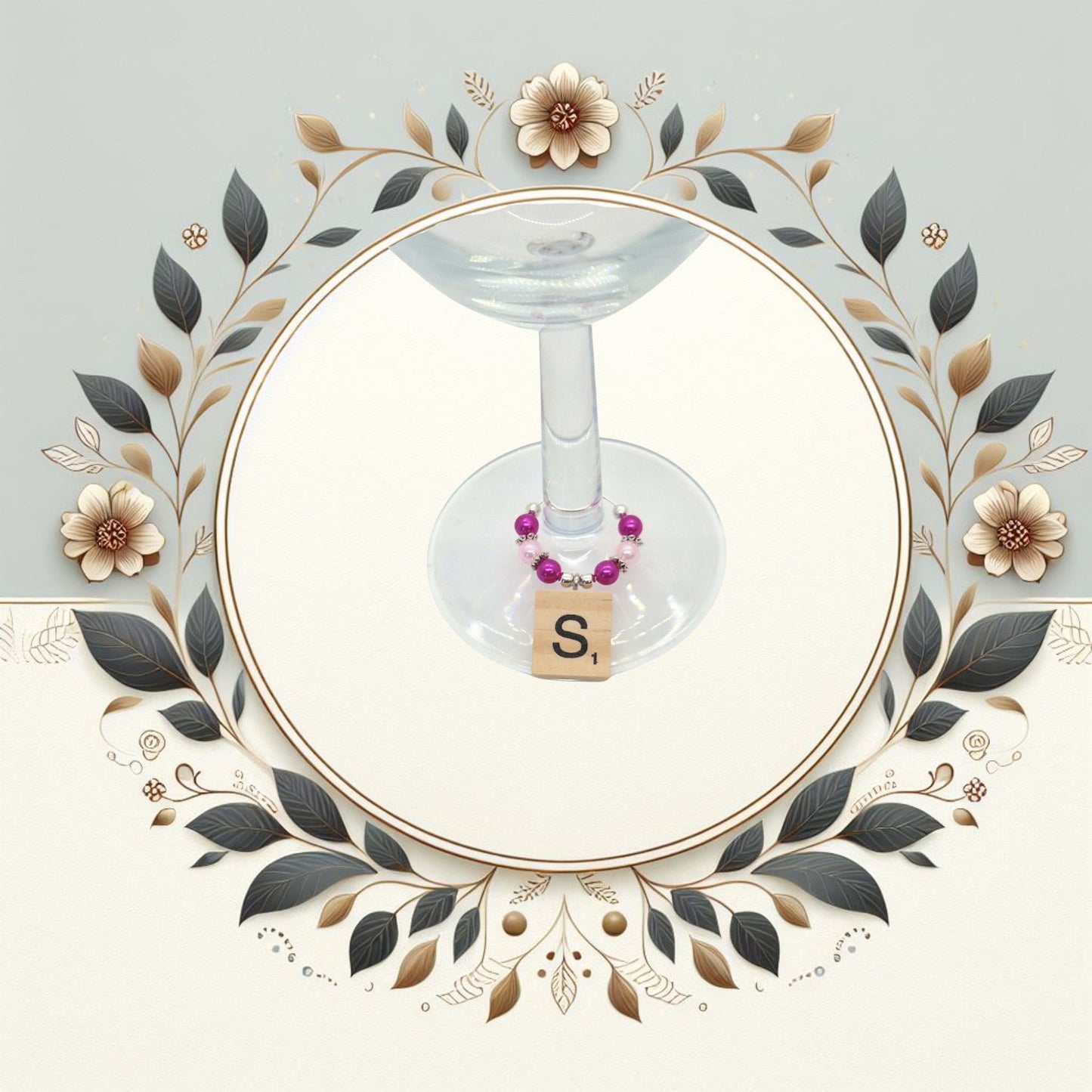 Wine glass charms with coloured beads and scrabble tile letter placed ona a wine glass stem.  Image in a floral circle.