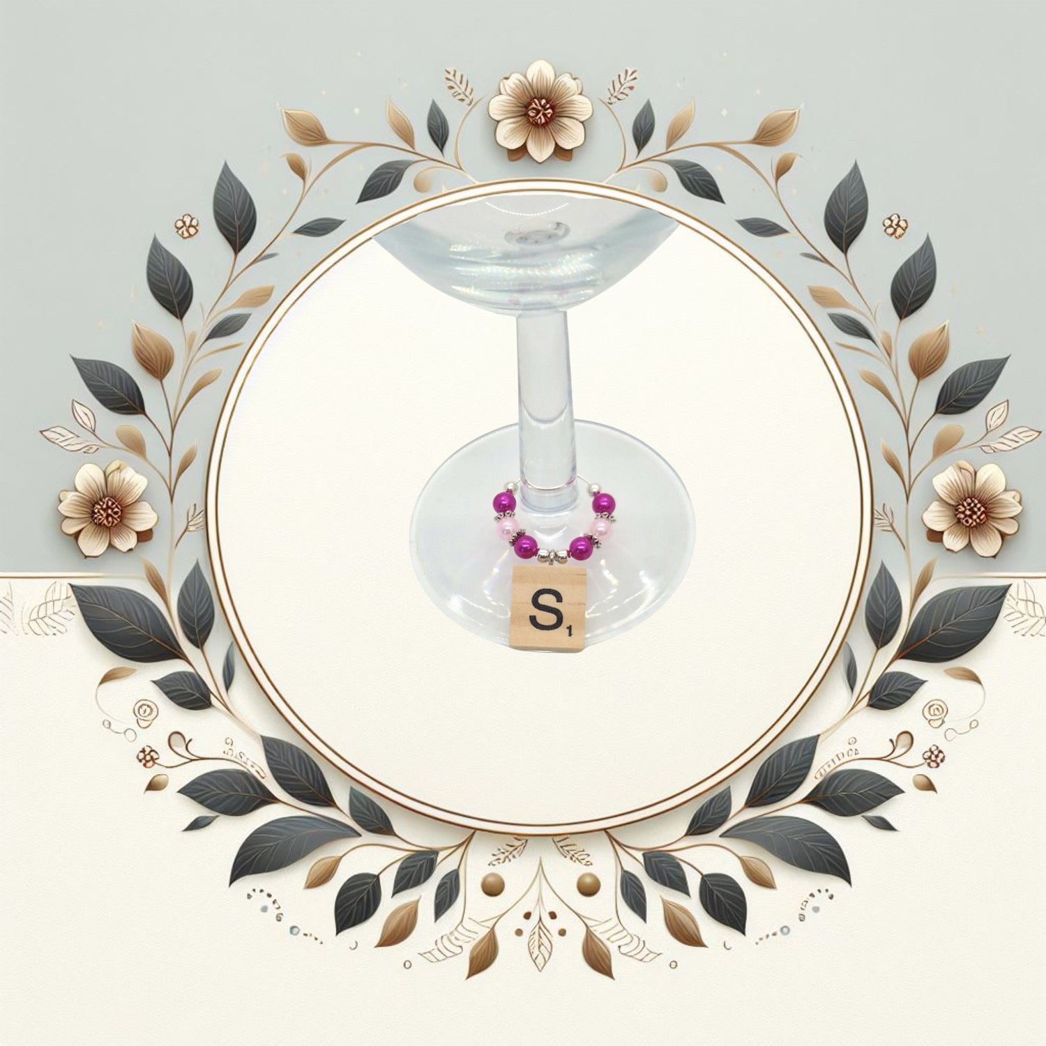 Wine glass charms with coloured beads and scrabble tile letter placed ona a wine glass stem.  Image in a floral circle.
