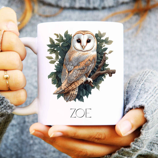 Person holding a mug with an owl design and 'ZOE' branding.