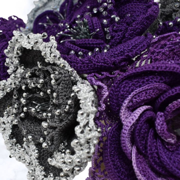 Close-up of purple and grey floral patterns with bead embellishments