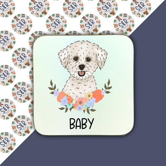 A square coaster with an illustration of a Bichon Frise dog surrounded by a floral pattern, with the text 'BABY' at the bottom.