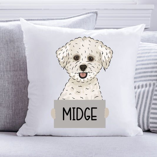 A square-shaped white cushion with an illustration of a Bichon Frise dog in the centre, with the name 'Midge' below it.
